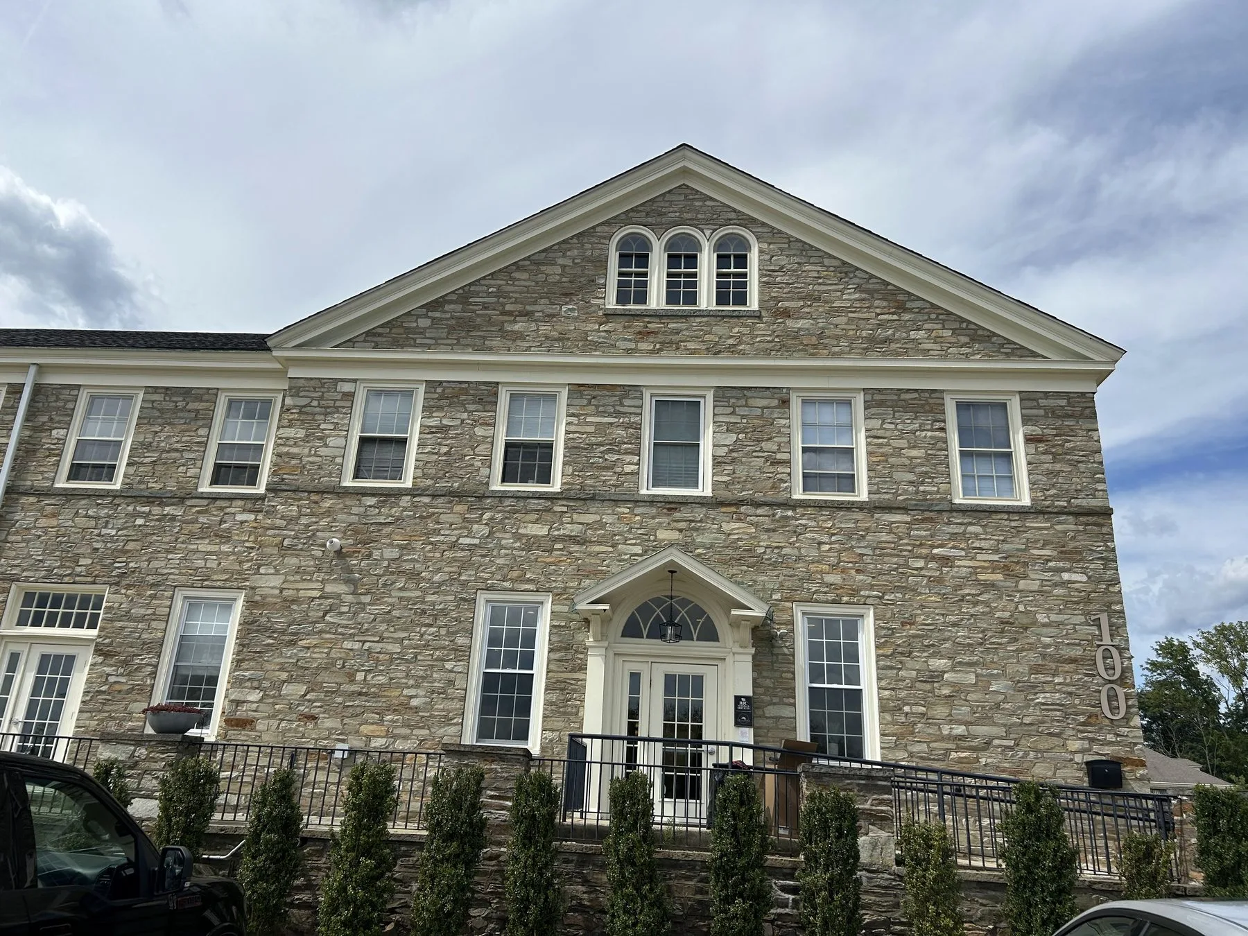 Stone building housing the Brave Embers Wellness office in Doylestown, with white-trimmed windows and an arched front entrance.